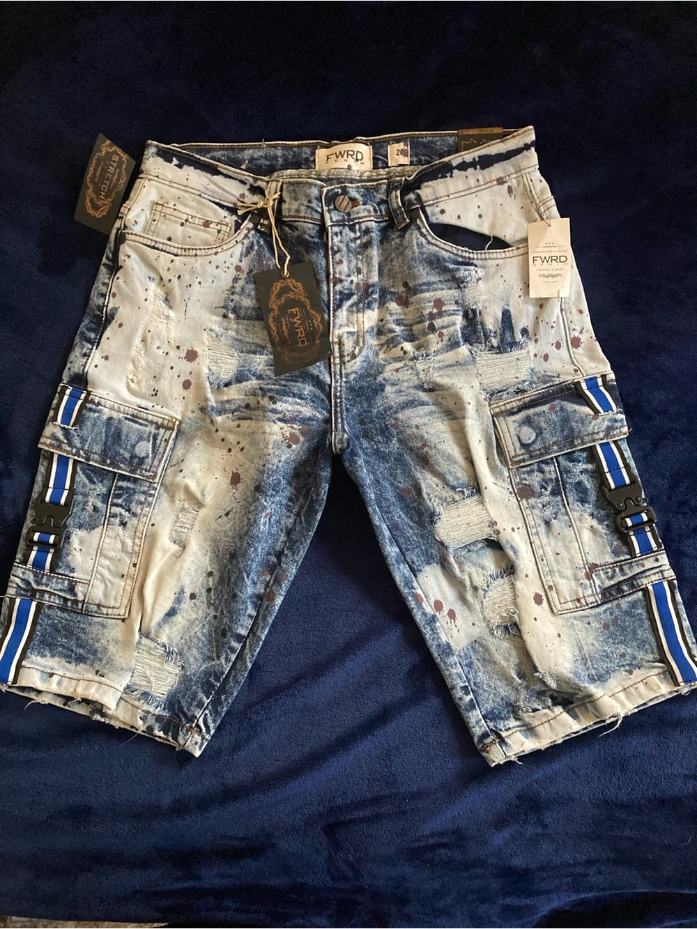 FWRD mens denim New York featuring paint splatter and side buckle cargo pockets